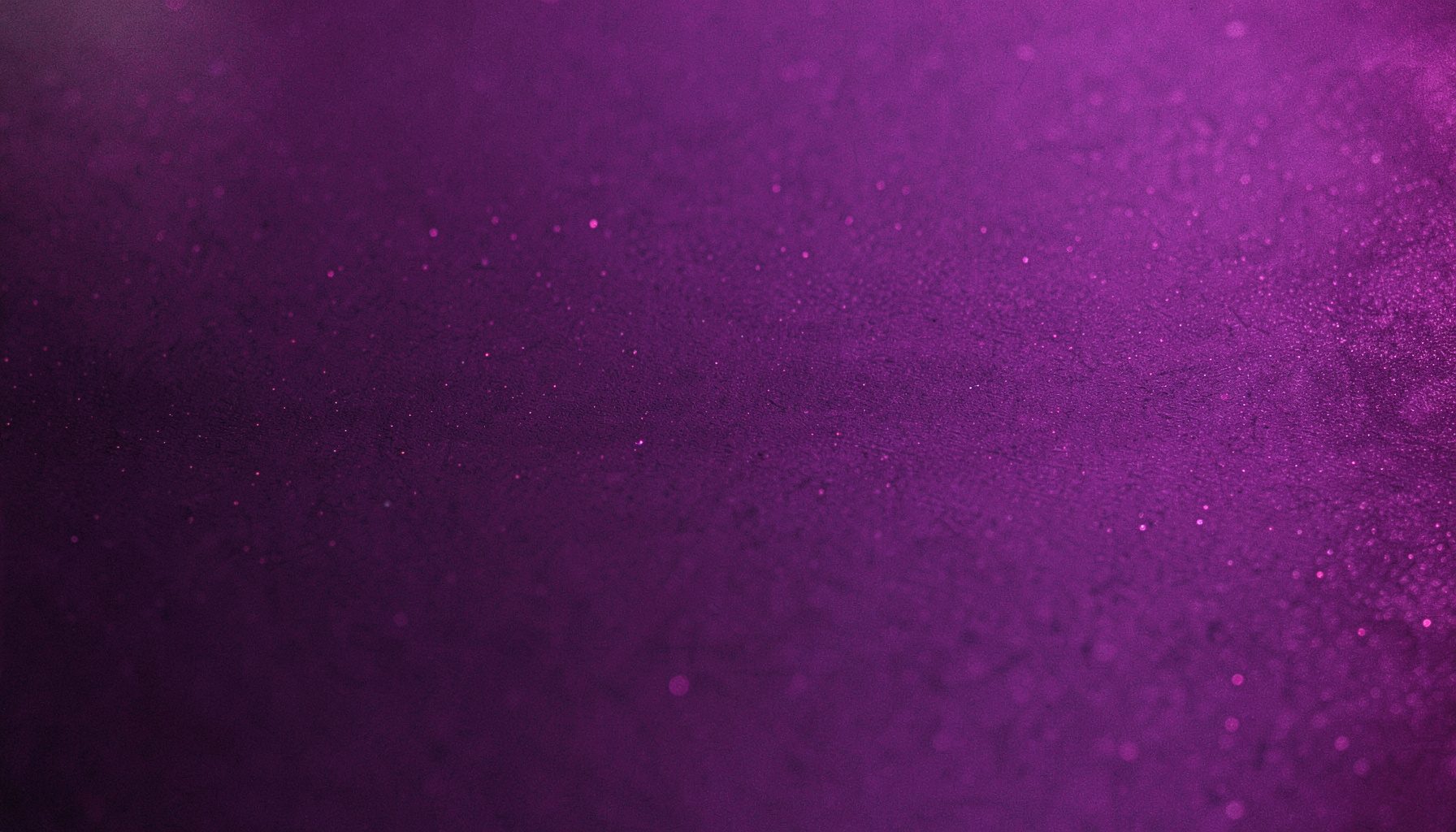 A dark card surface with a soft violet gradient and subtle shimmering highlights, evoking a premium digital atmosphere