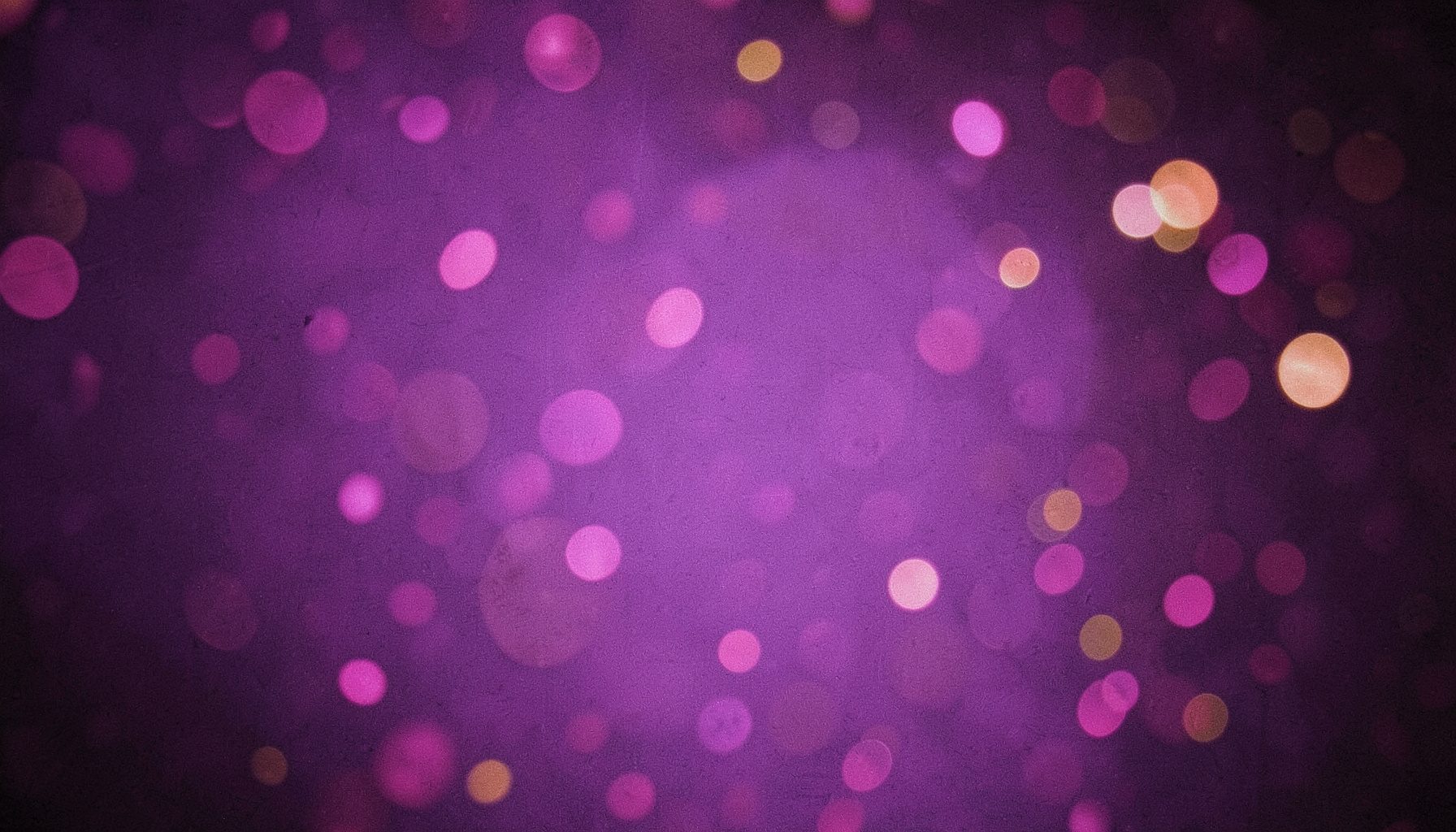 A moody violet backdrop with scattered soft bokeh circles in magenta and gold, creating a sense of depth